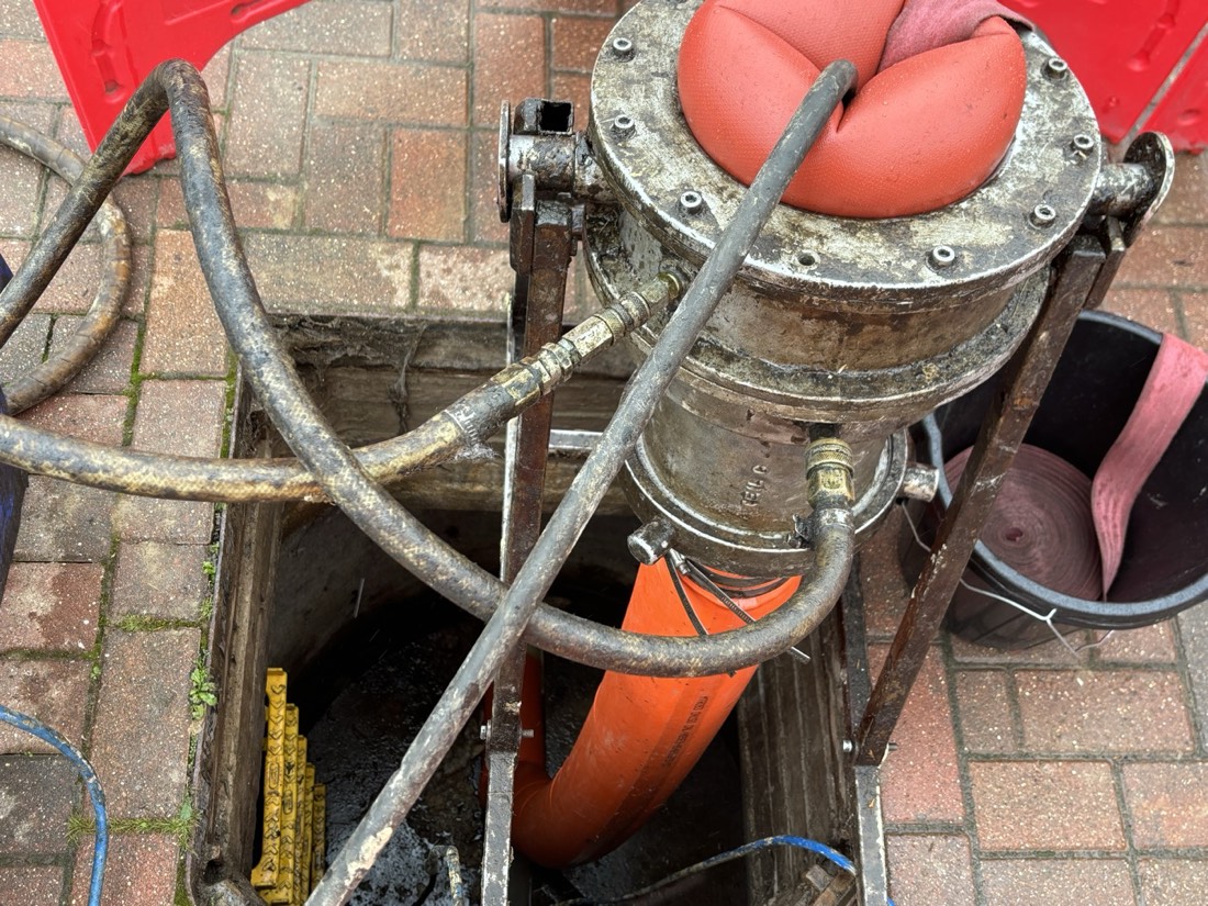 No-dig inversion drain lining equipment at a manhole